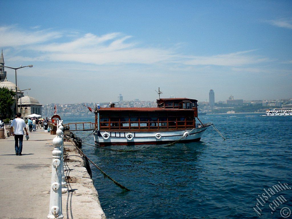 View of the shore, a fisher boat and Semsi Pasha Mosque in Uskudar district of Istanbul city of Turkey.
