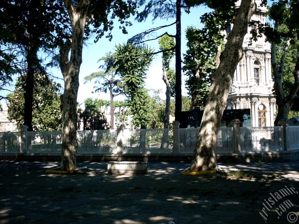 View of Dolmabahce Palace`s entrance and clock tower located in Dolmabahce district in Istanbul city of Turkey.
