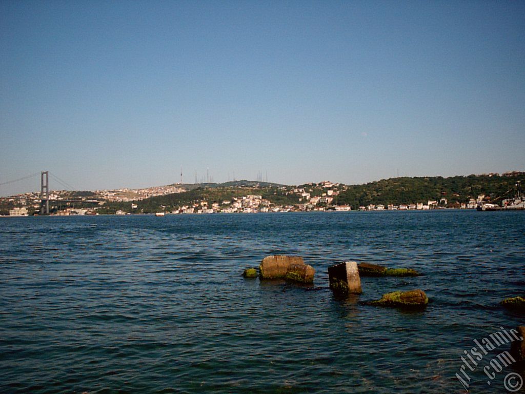 View of the Bosphorus Bridge, Camlica Hill and Uskudar-Beylerbeyi coast from a park at Besiktas shore in Istanbul city of Turkey.
