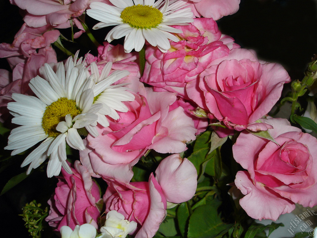 A bouquet consisting of rose, daisy and snapdragon flowers.
